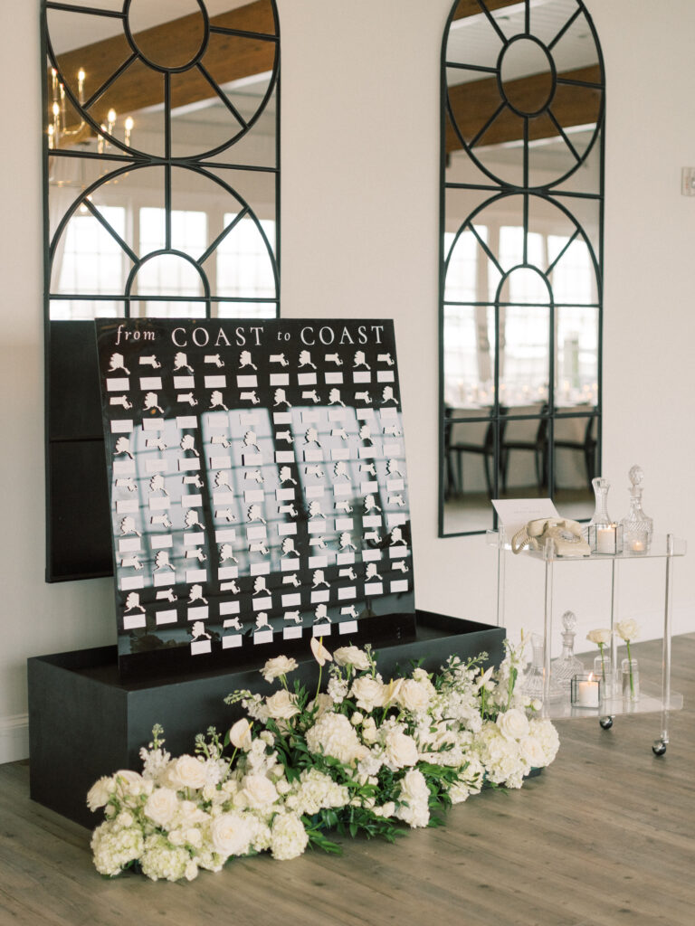 Black and white escort card display with U.S. state cutouts for seating