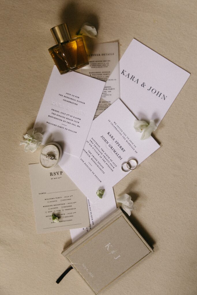 Modern monogrammed wedding invitations for Kara and John’s Crane Estate wedding styled with florals and personal touches.