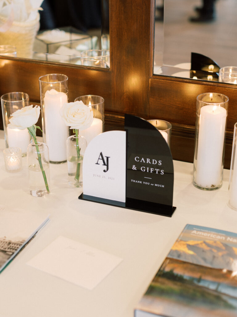 Black and white wedding cards and gifts sign with candles and roses