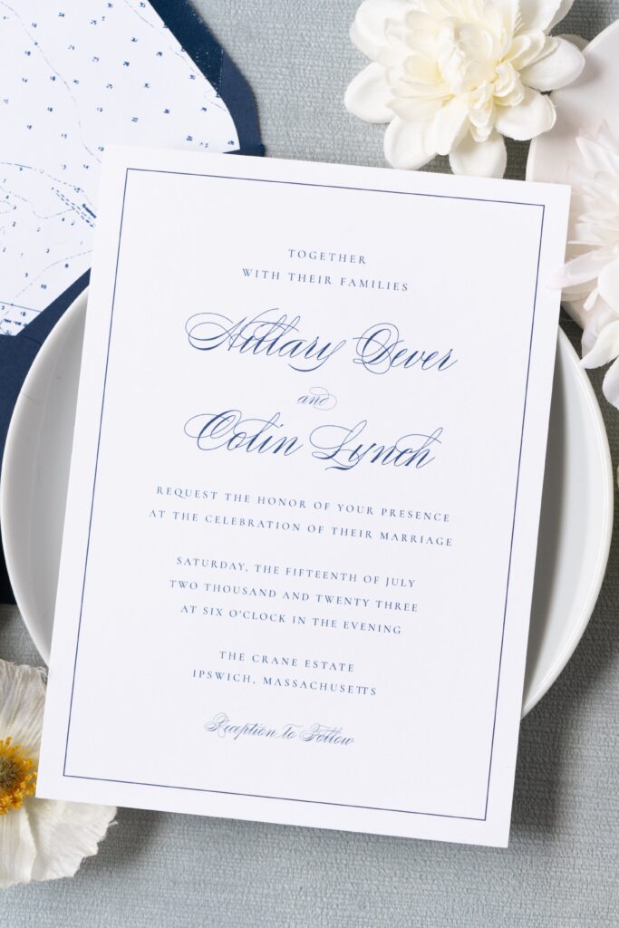Digitally printed navy and white wedding invitation for a Crane Estate wedding, styled with white flowers